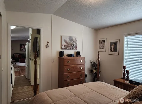 a bedroom with a bed and a dresser