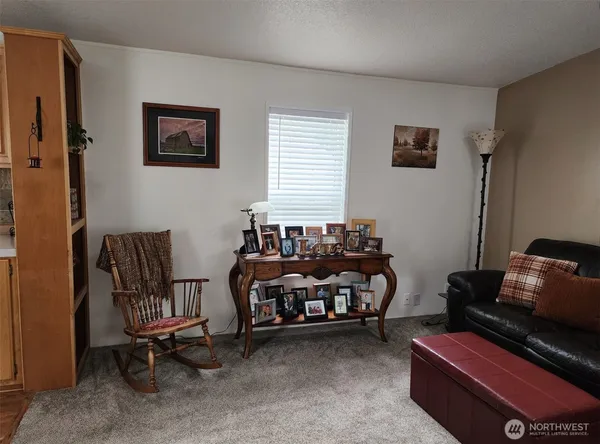 a living room with furniture and a piano