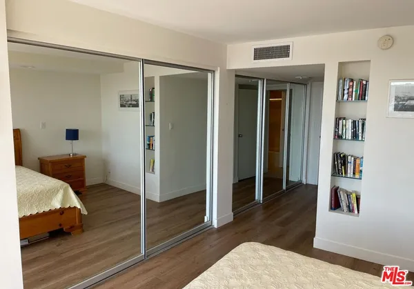 a bedroom with bed and walk in closet