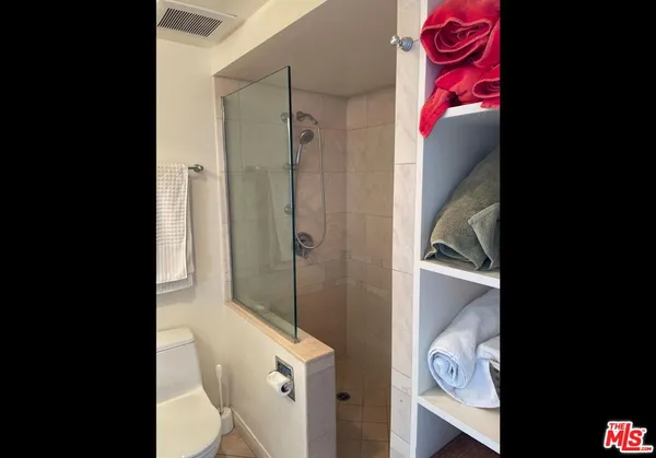 a bedroom with a bed and chair