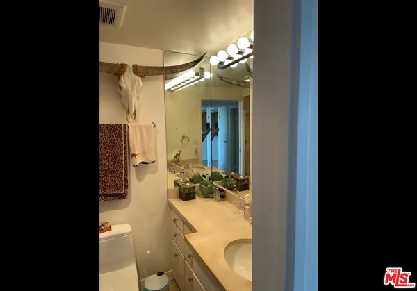 a bathroom with a sink double vanity and a mirror