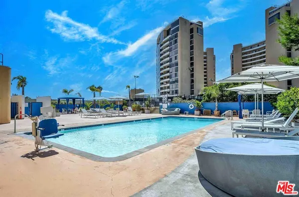 a view of a swimming pool with outdoor seating