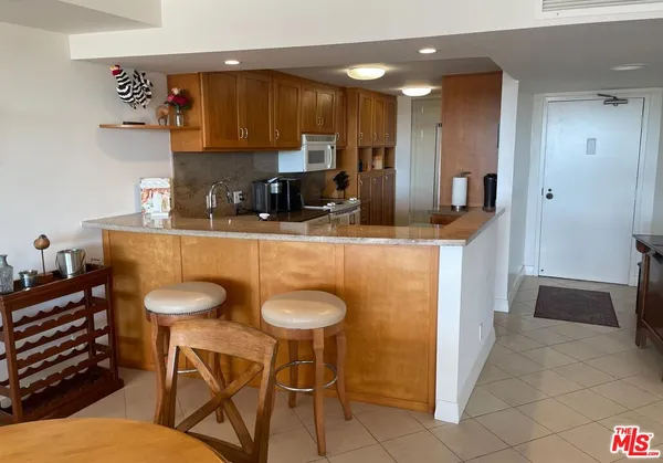 a kitchen with stainless steel appliances granite countertop a sink and a refrigerator