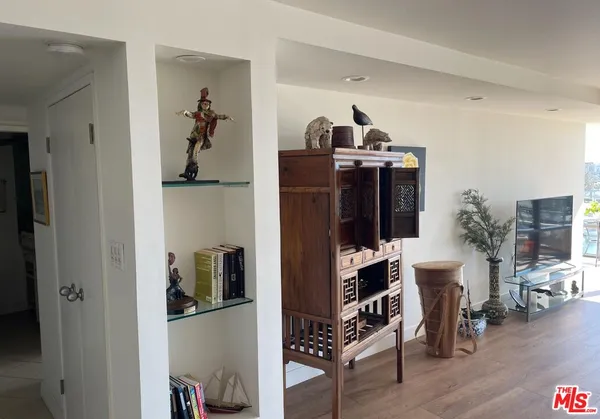 a view of living room with furniture and wooden floor