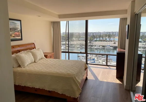 a bedroom with a large bed and a large window