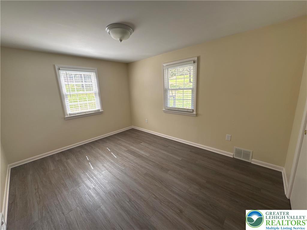 3676 Lower Saucon Road Hellertown, PA 18055 - Photo 14 of 20 a view of an empty room with wooden floor and a window