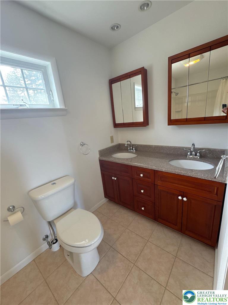 3676 Lower Saucon Road Hellertown, PA 18055 - Photo 17 of 20 a spacious bathroom with a toilet a sink and mirror