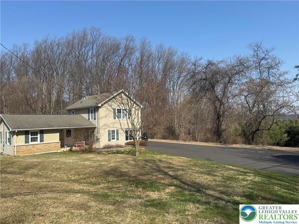3676 Lower Saucon Road Hellertown, PA 18055 - Photo 2 of 20 a house with trees in the background
