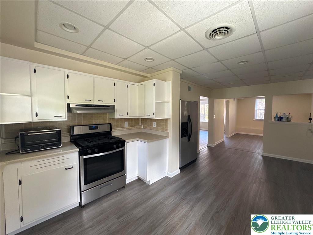3676 Lower Saucon Road Hellertown, PA 18055 - Photo 8 of 20 a kitchen with stainless steel appliances a stove a sink and white cabinets