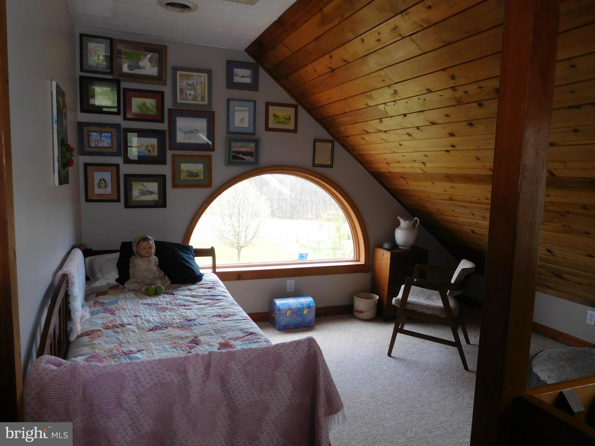 1204 North Timber Ridge Road Cross Junction, VA 22625 - Photo 14 of 28 a bed room with a bed and a chair