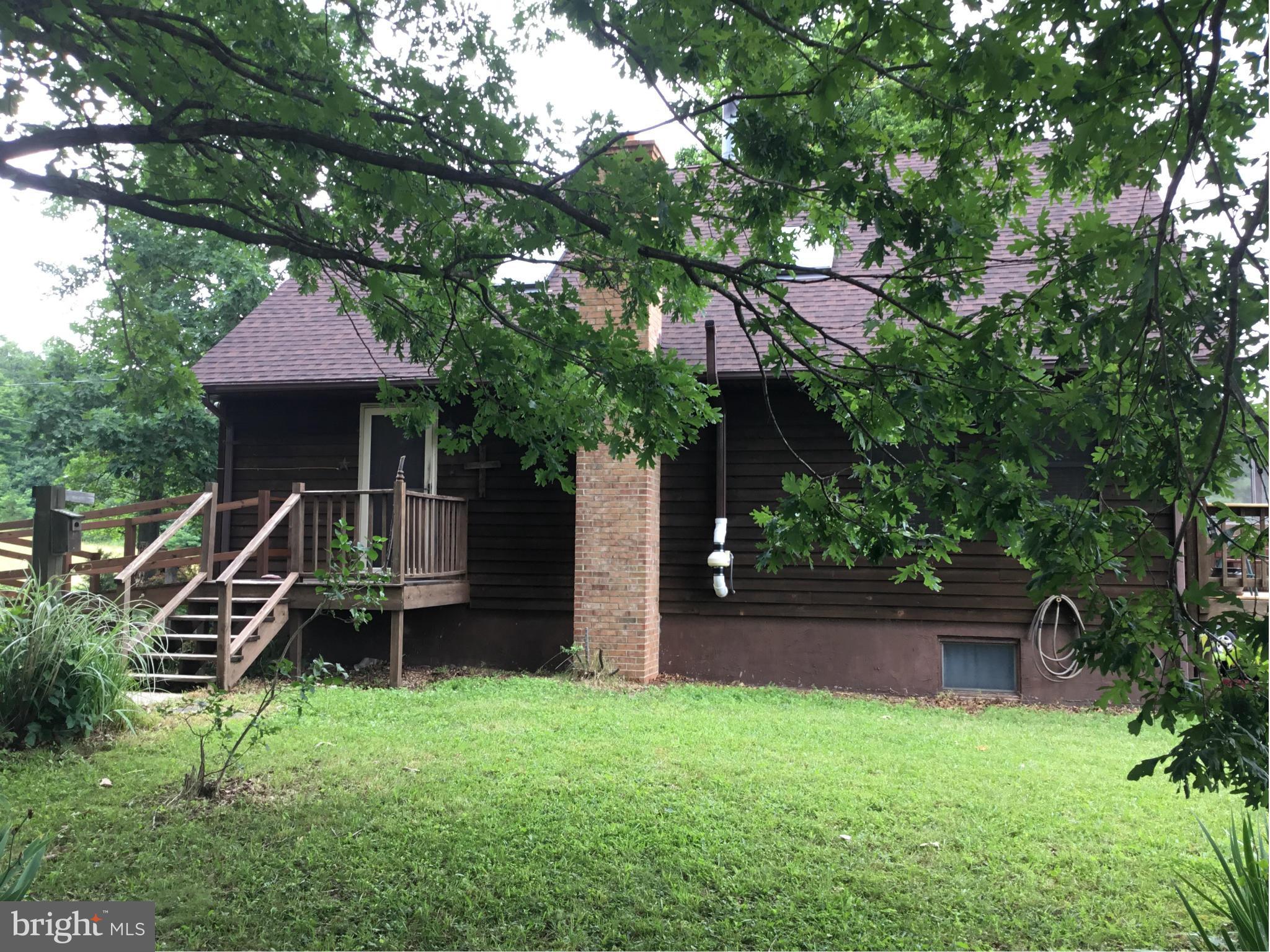 1204 North Timber Ridge Road Cross Junction, VA 22625 - Photo 3 of 28 a front view of a house with a garden