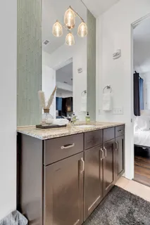 a kitchen with stainless steel appliances granite countertop a sink and a refrigerator