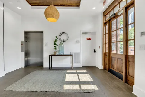 a view of entryway with a front door and a rug