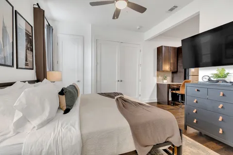 a bedroom with a bed and a flat screen tv