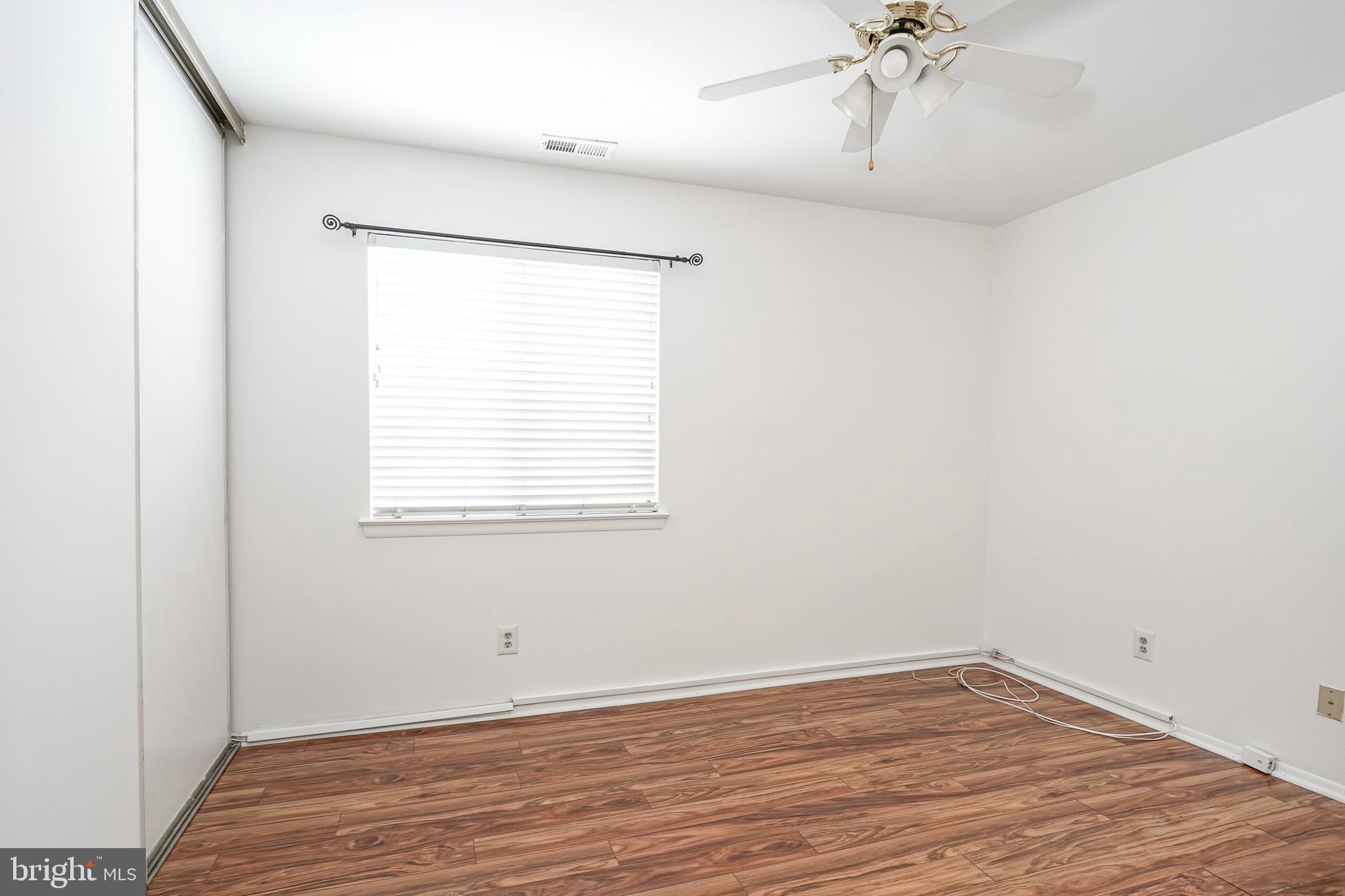 2012 Raven's Row Marlton, NJ 08053 - Photo 13 of 23 a view of an empty room with a window and wooden floor