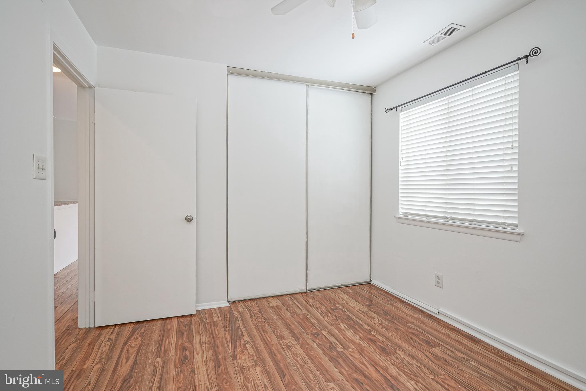 2012 Raven's Row Marlton, NJ 08053 - Photo 14 of 23 a view of an empty room with wooden floor and a window