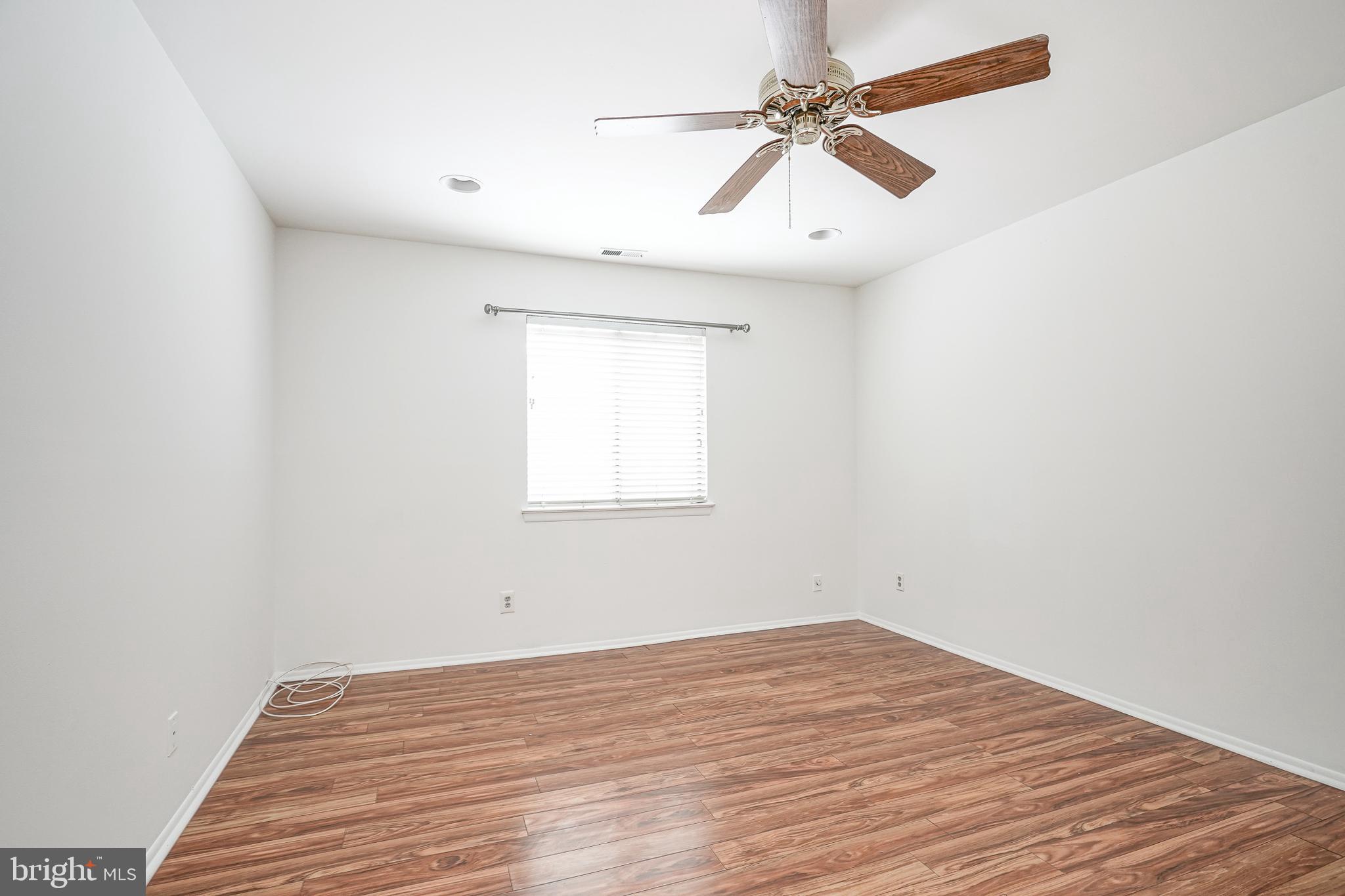 2012 Raven's Row Marlton, NJ 08053 - Photo 17 of 23 an empty room with a window and a ceiling fan