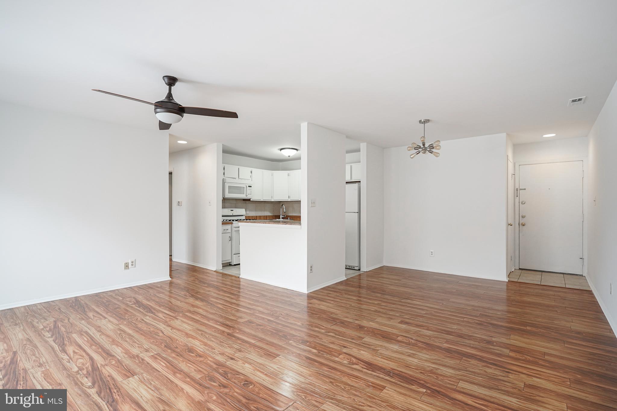 2012 Raven's Row Marlton, NJ 08053 - Photo 3 of 23 a view of empty room with wooden floor and kitchen