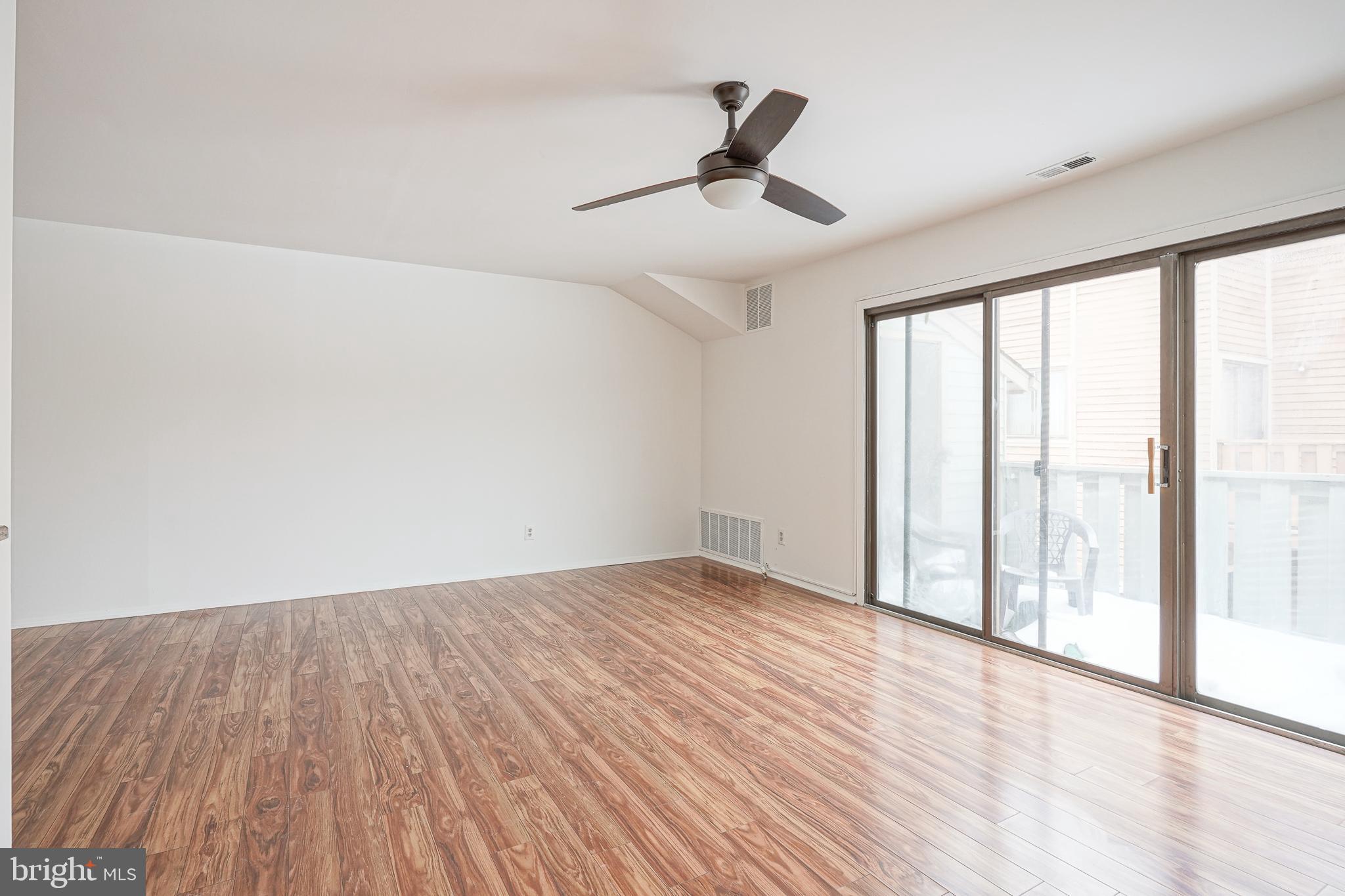 2012 Raven's Row Marlton, NJ 08053 - Photo 6 of 23 a view of empty room with wooden floor and fan