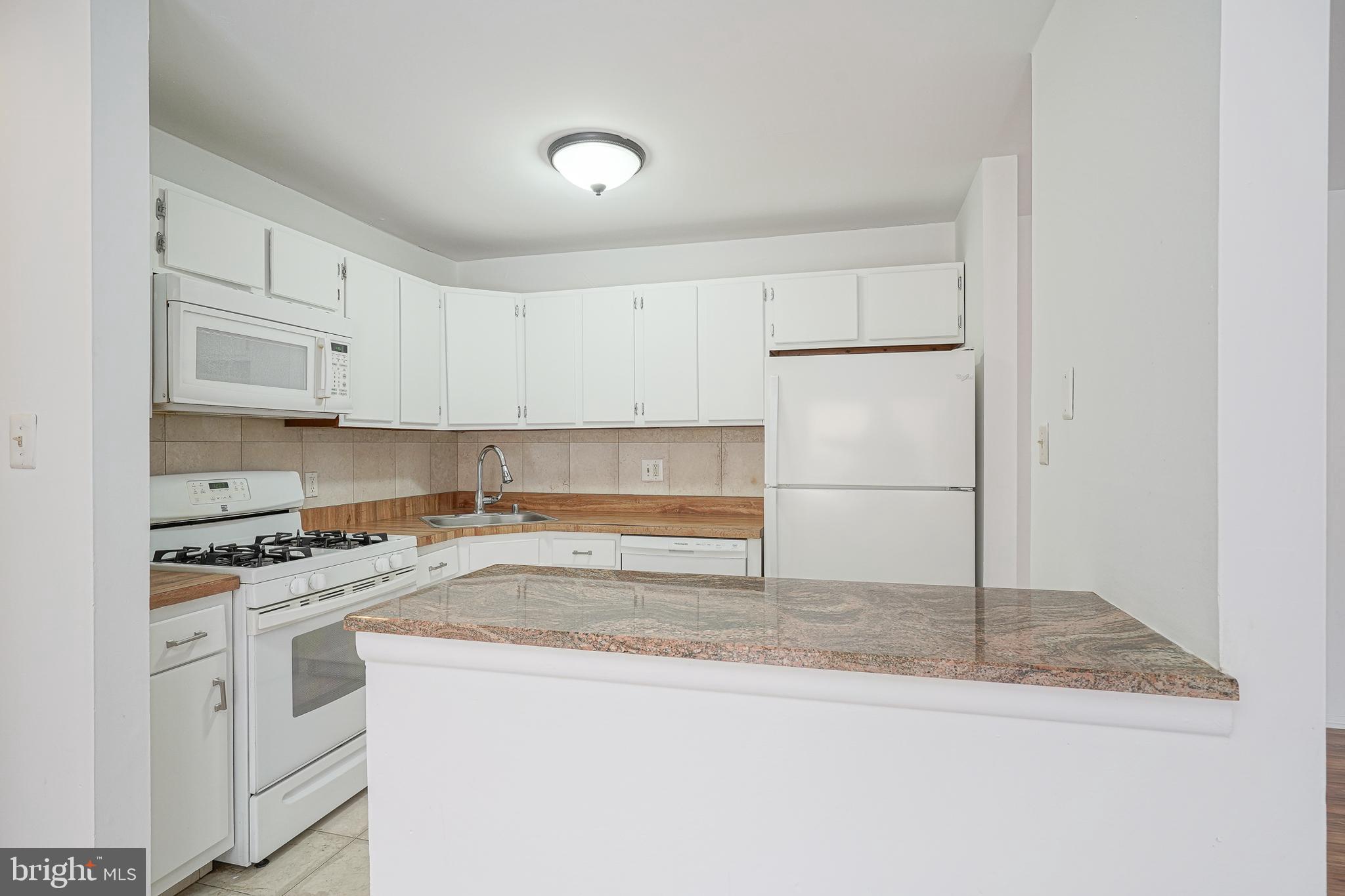 2012 Raven's Row Marlton, NJ 08053 - Photo 9 of 23 a kitchen with white cabinets and white appliances