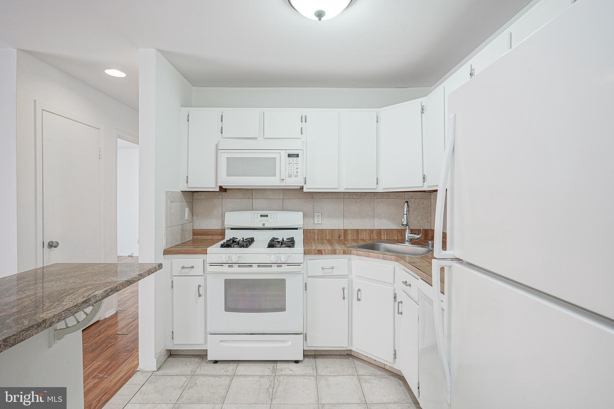 2012 Raven's Row Marlton, NJ 08053 - Photo 10 of 23 a kitchen with white cabinets stainless steel appliances and sink