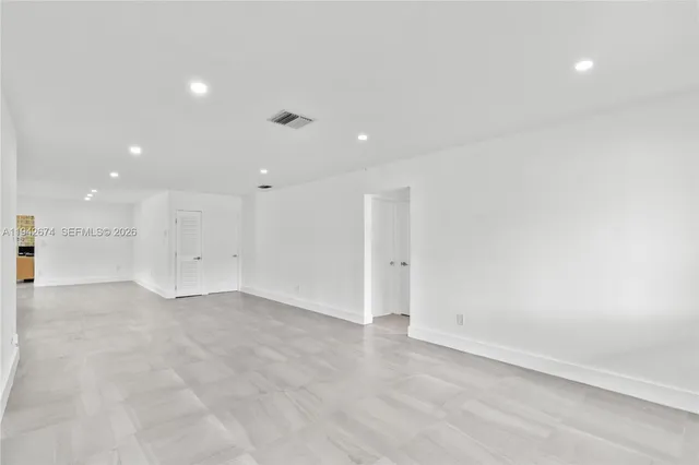 a view of kitchen with stainless steel appliances granite countertop a stove and a sink