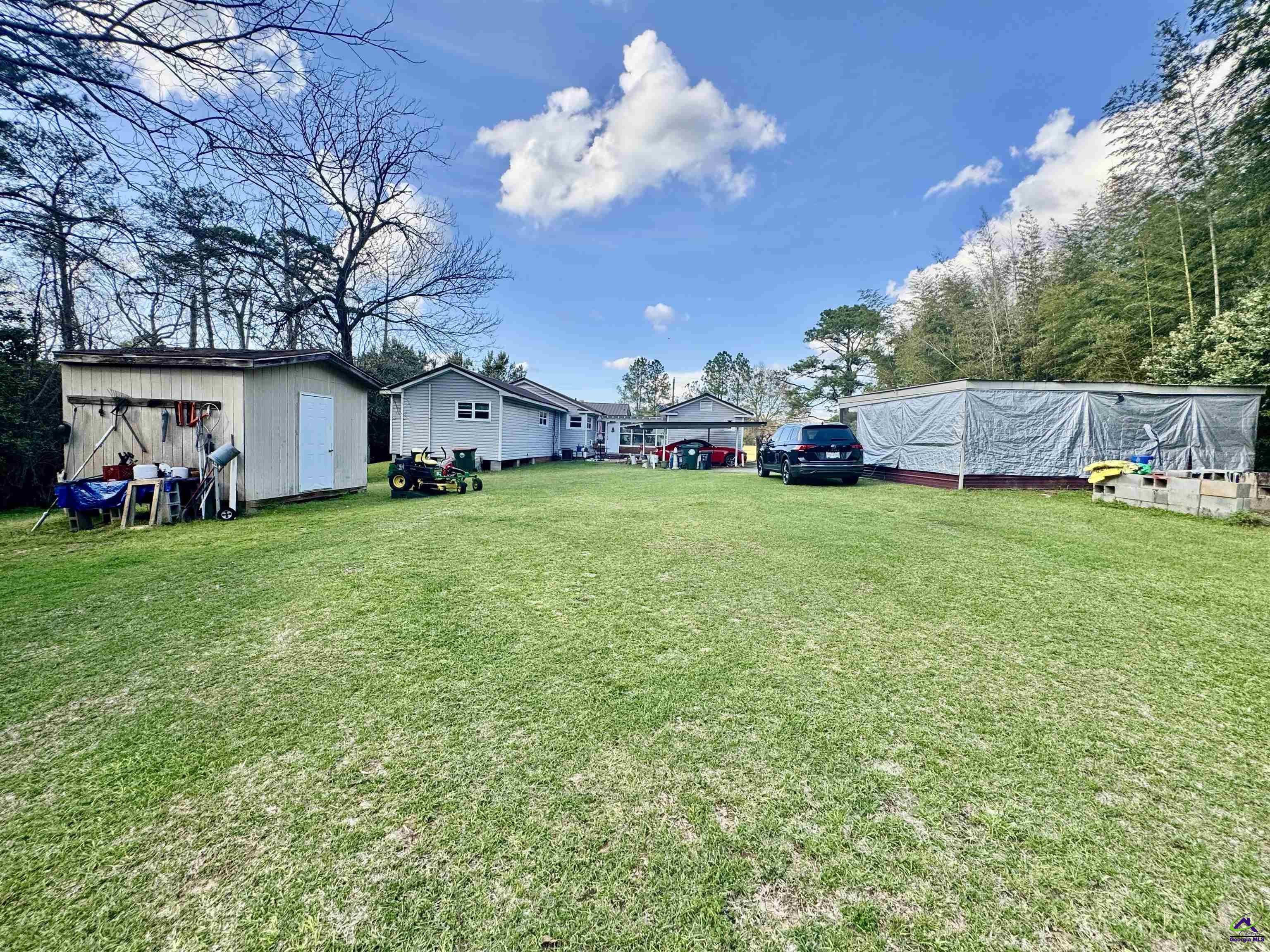 914 Adderton Street Americus, GA 31719 - Photo 9 of 53 a view of a yard with a house and a large tree