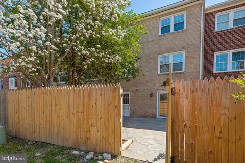 a view of a house with a wooden fence
