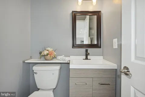 a bathroom with a toilet sink and mirror
