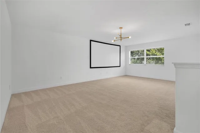 a view of a swimming pool with a yard and plants