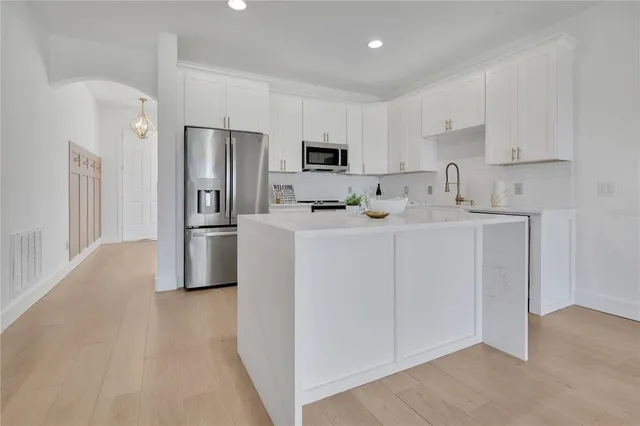 a kitchen with stainless steel appliances a sink stove and refrigerator