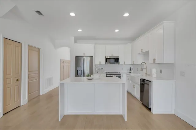 a view of a livingroom with wooden floor and stairs