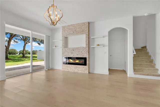 a view of a kitchen with a fireplace a kitchen island and stainless steel appliances