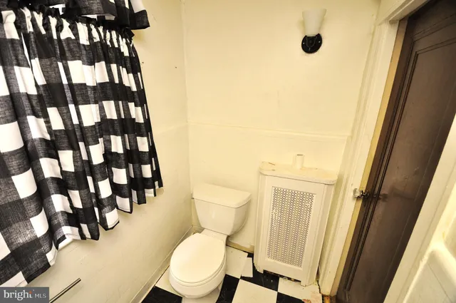 a white toilet sitting next to a bathroom sink
