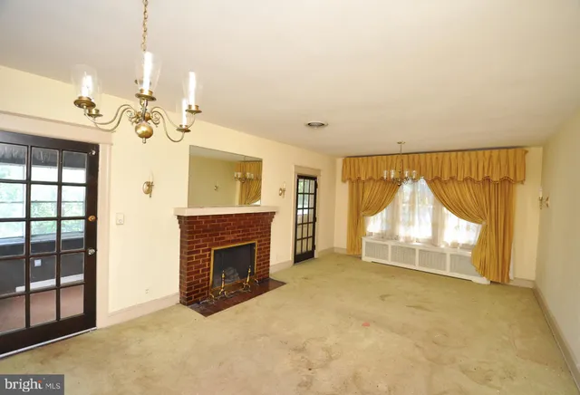 wooden floor fireplace and windows in an empty room