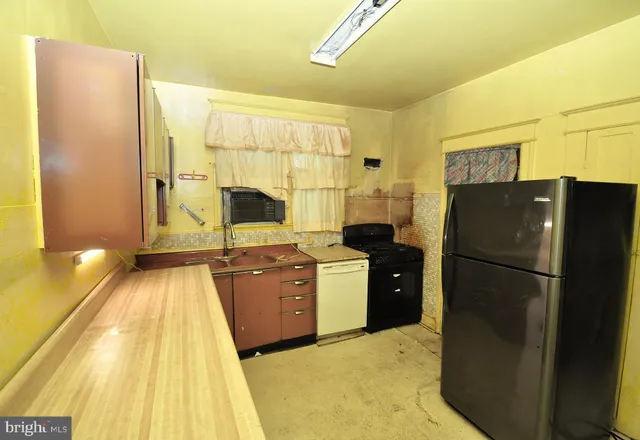 a kitchen with a refrigerator and a stove