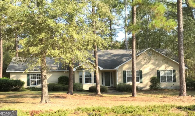 a view of a white house with a yard
