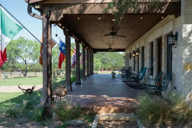 a dining room with furniture and a floor to ceiling window