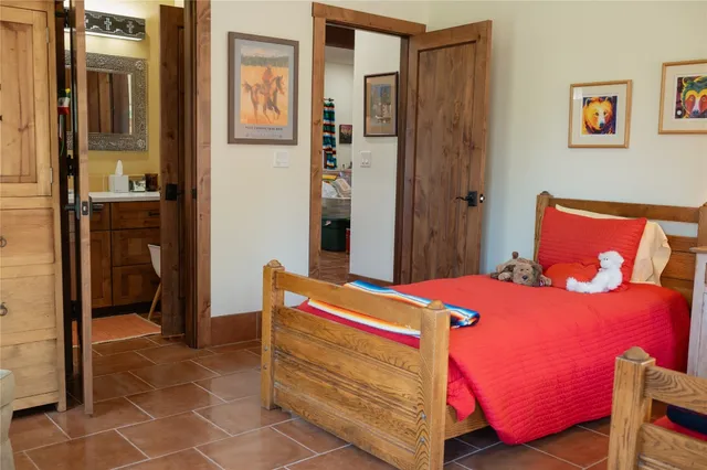 a bed sitting in a bedroom next to a window