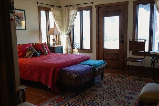 a room with furniture a flat screen tv and a large window