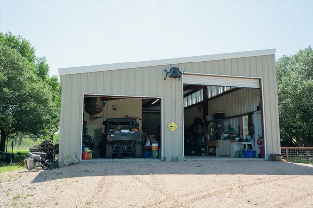 a backyard of a house with yard table and chairs