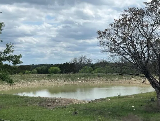 a view of a backyard with table and chairs under an umbrella