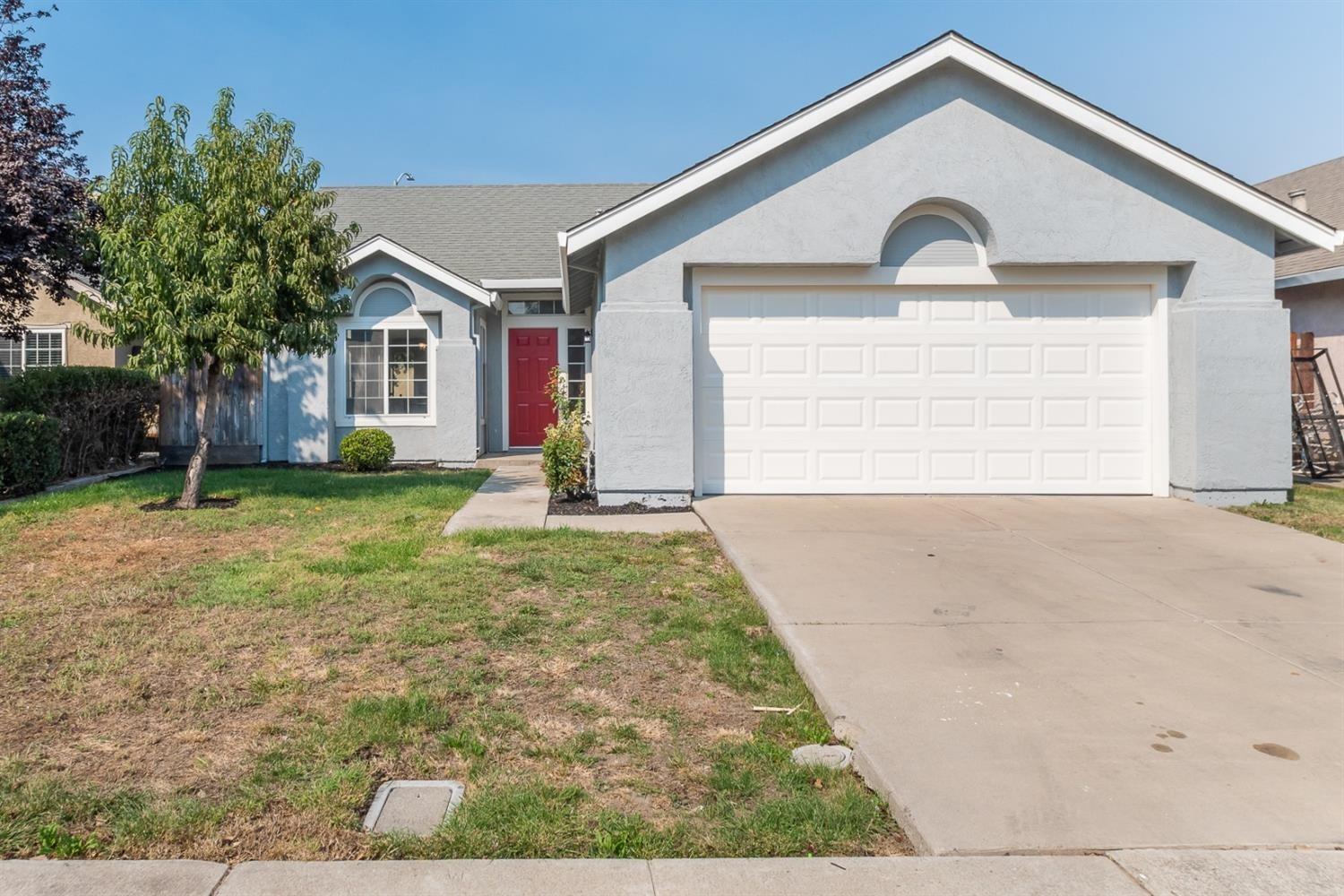 2005 Quaker Ridge Court Stockton, CA 95206 - Photo 1 of 1 a front view of a house with a yard and garage