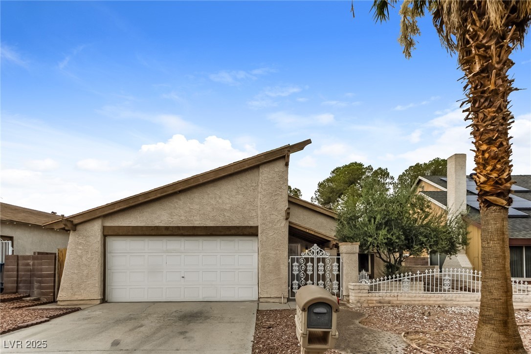 View of front facade with stucco siding, an attach