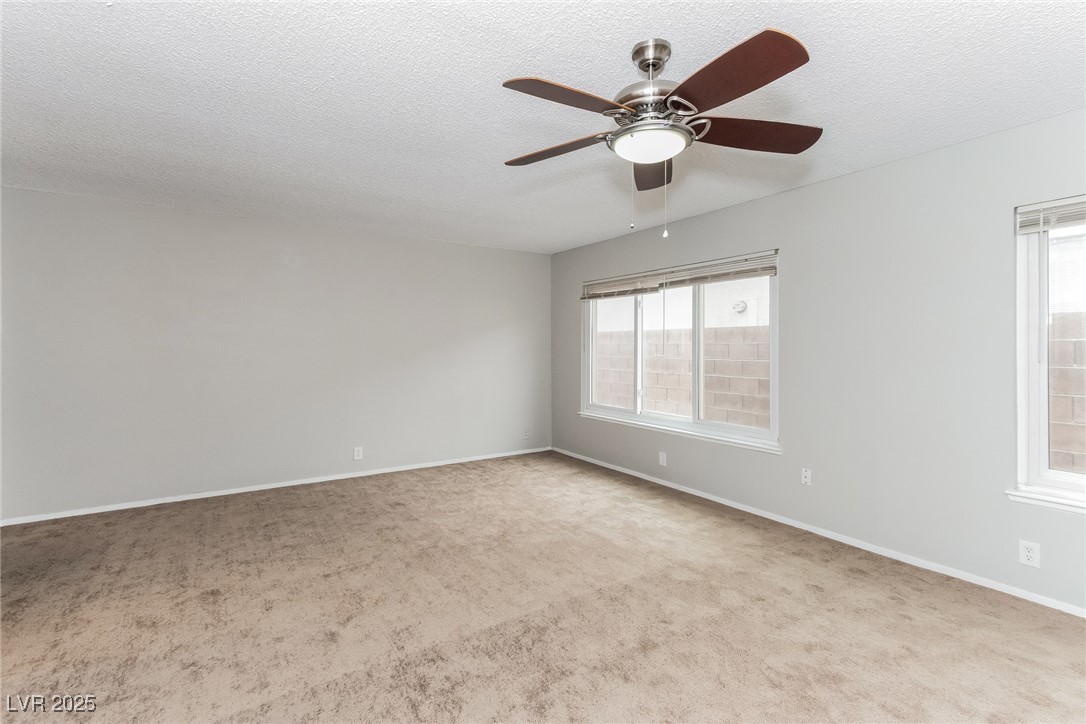 4737 Monaco Road Las Vegas, NV 89121 - Photo 14 of 21 Carpeted spare room featuring ceiling fan and a te