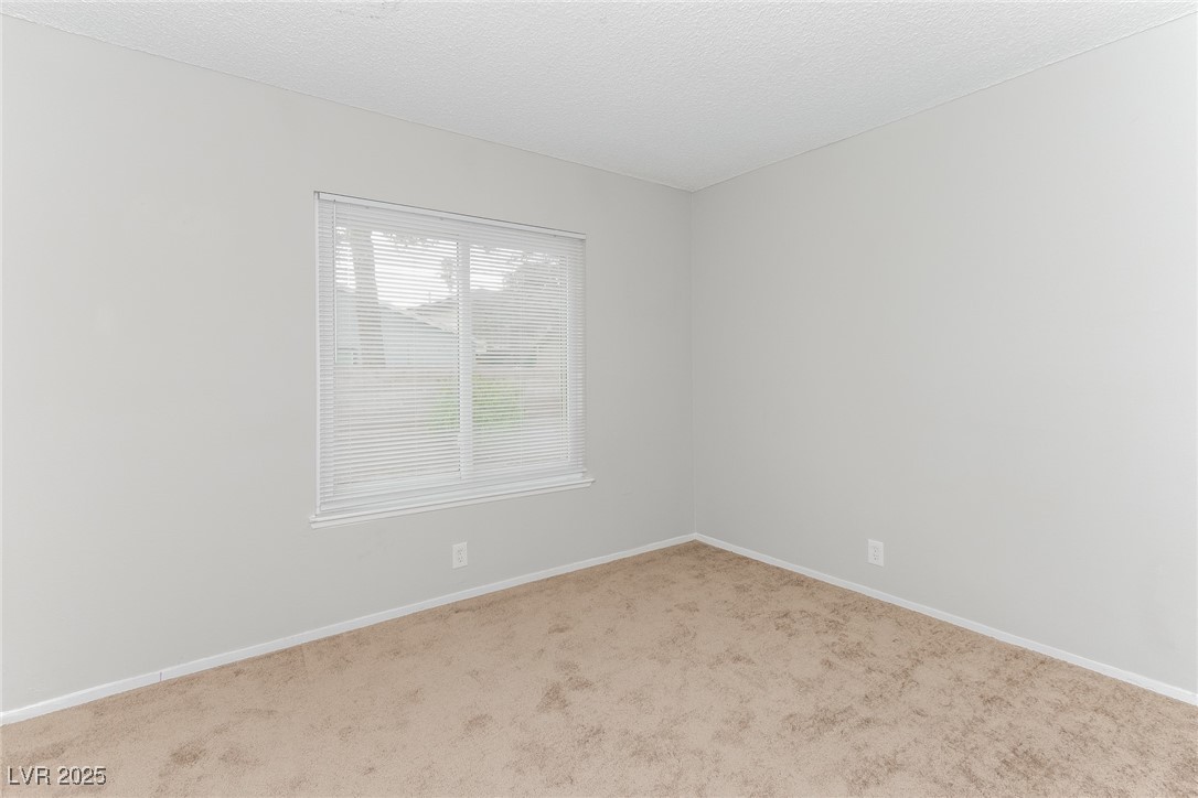 4737 Monaco Road Las Vegas, NV 89121 - Photo 16 of 21 Empty room with carpet flooring and baseboards