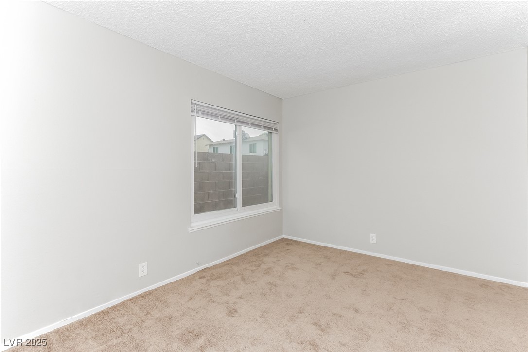 4737 Monaco Road Las Vegas, NV 89121 - Photo 17 of 21 Spare room featuring light colored carpet and a te