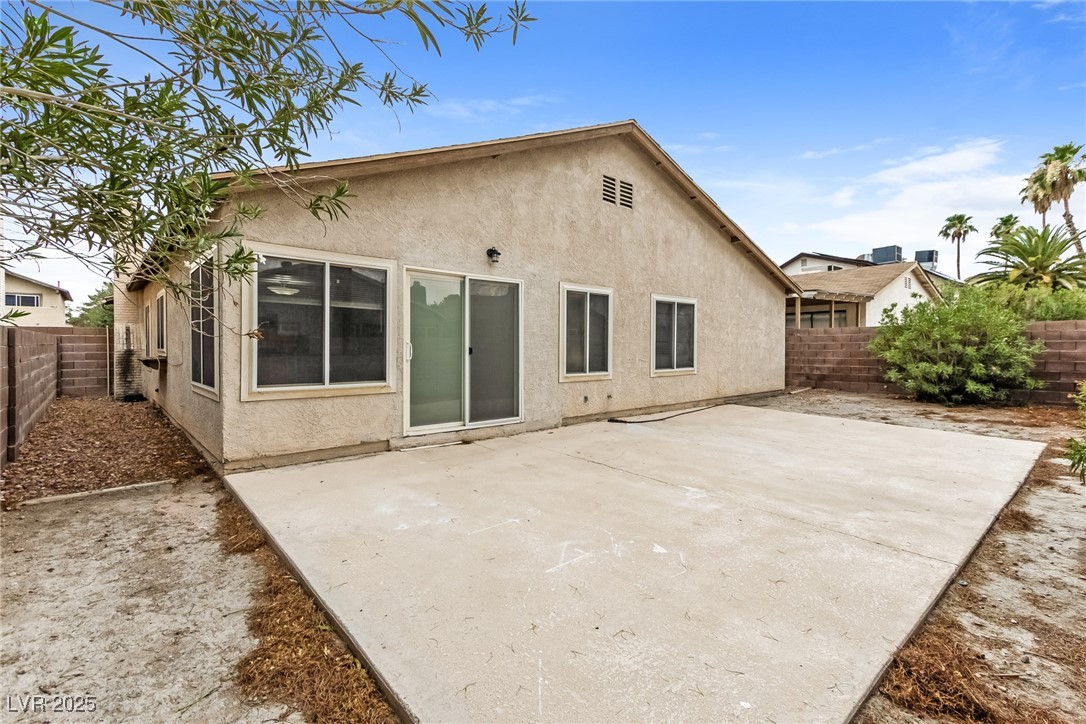 4737 Monaco Road Las Vegas, NV 89121 - Photo 19 of 21 Back of house with stucco siding, a fenced backyar