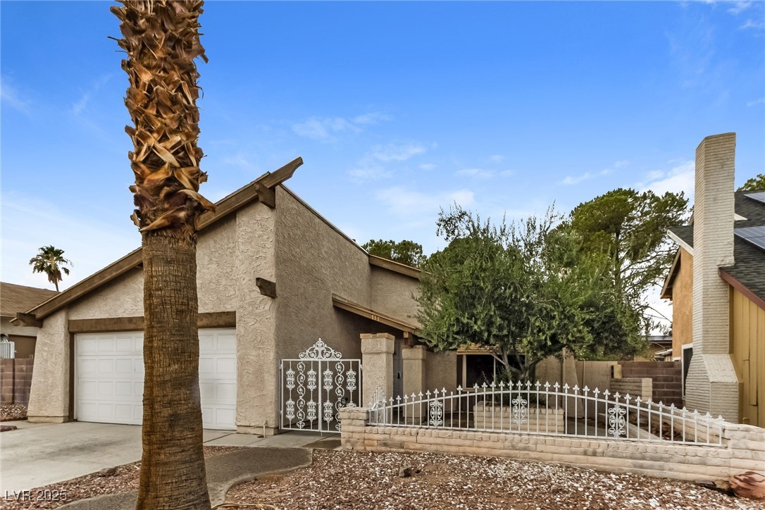 4737 Monaco Road Las Vegas, NV 89121 - Photo 2 of 21 View of front of property with stucco siding, driv