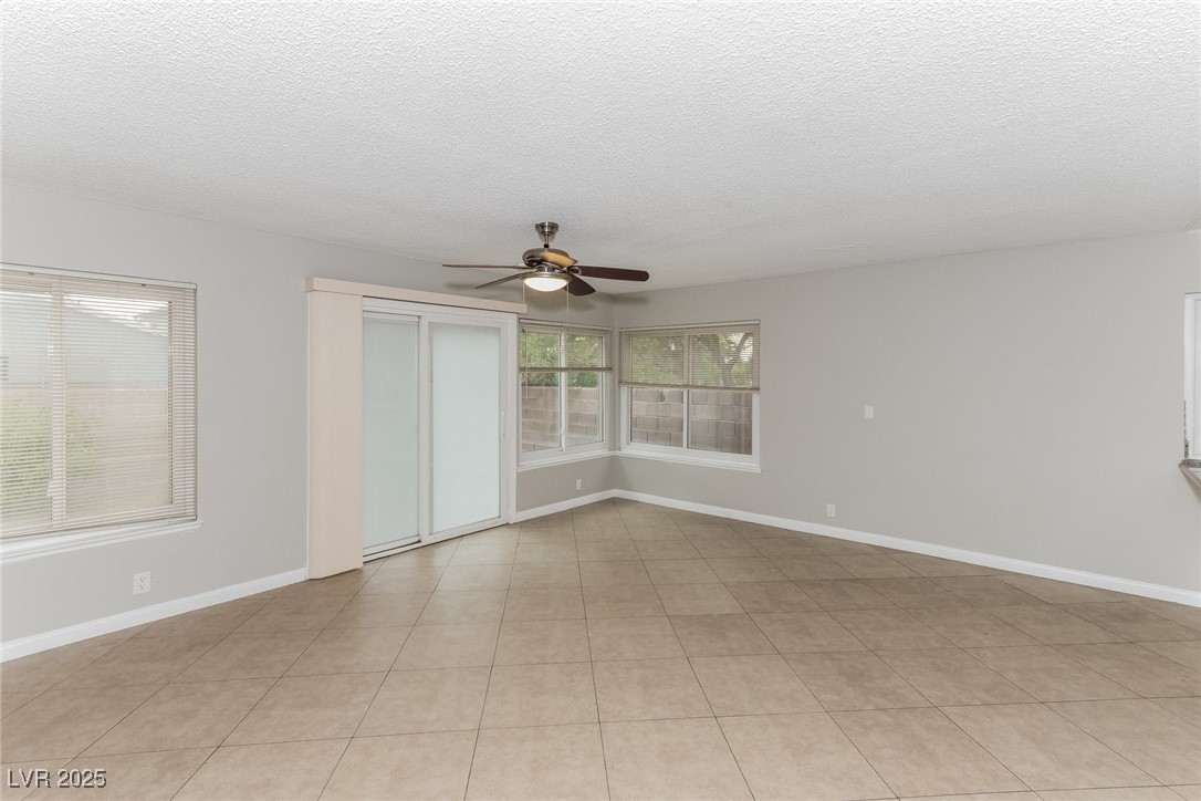 4737 Monaco Road Las Vegas, NV 89121 - Photo 3 of 21 Empty room with ceiling fan and a textured ceiling